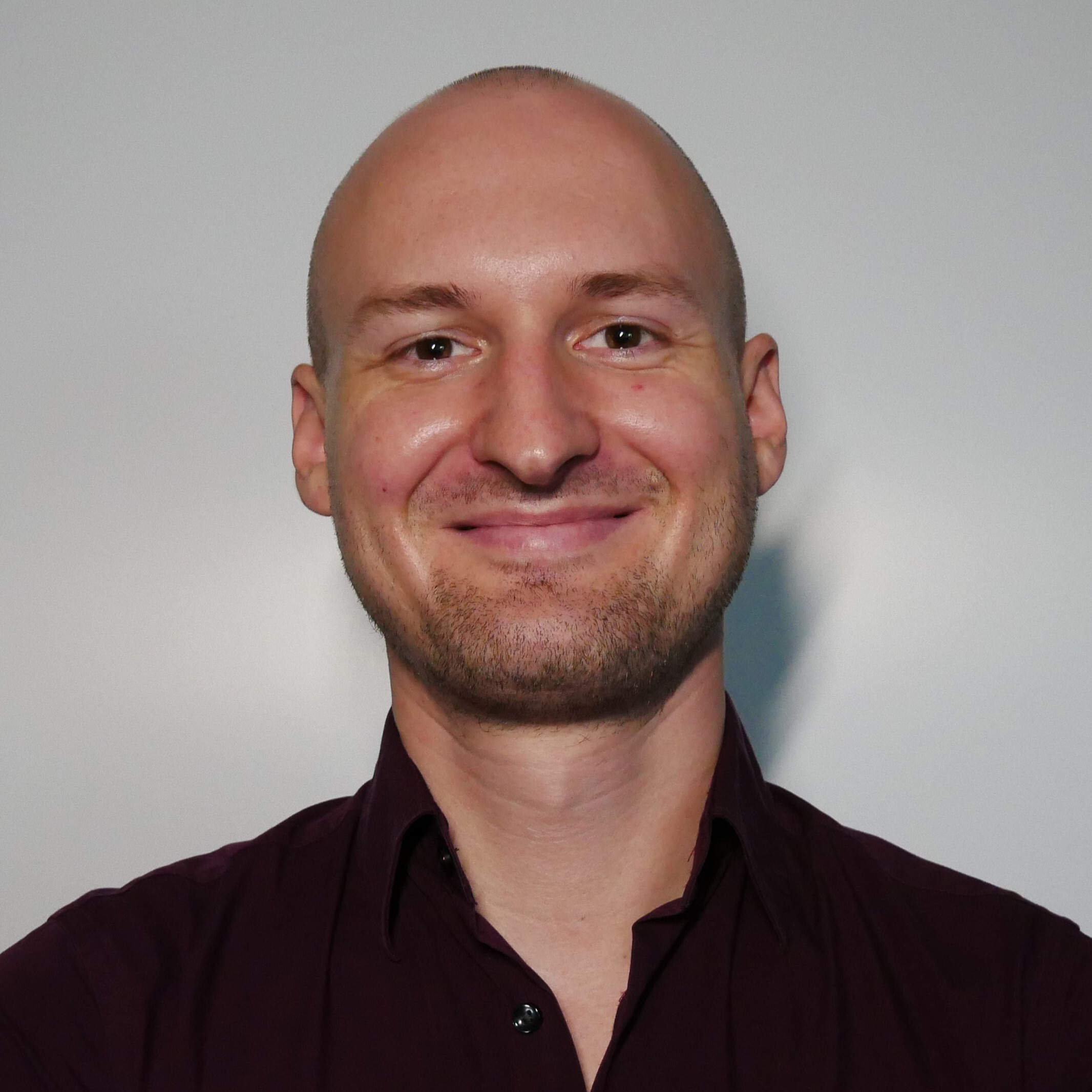 Headshot of Marvin Wolf. He is smiling into the camera and wearing a dark shirt.